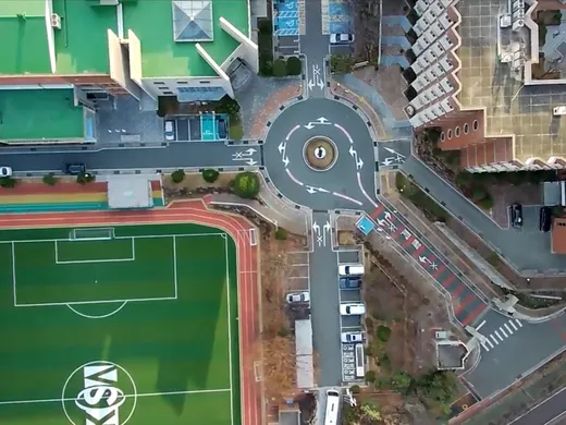 Overhead view of a school campus and its playing field.