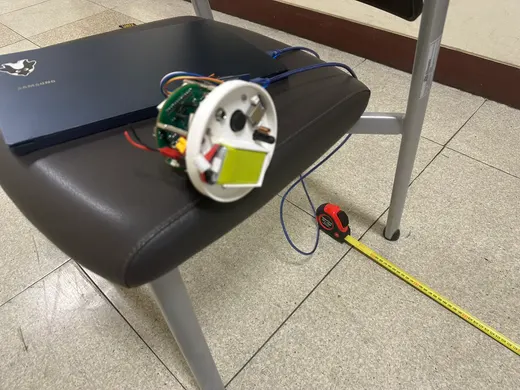 Electronics and a cylindrical research prototype on a workbench.